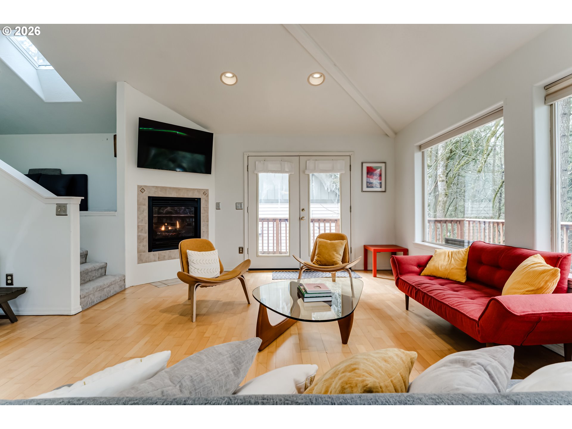 2736 Kismet Way Eugene, OR 97405 - Photo 10 of 48 a living room with furniture a flat screen tv and a fireplace