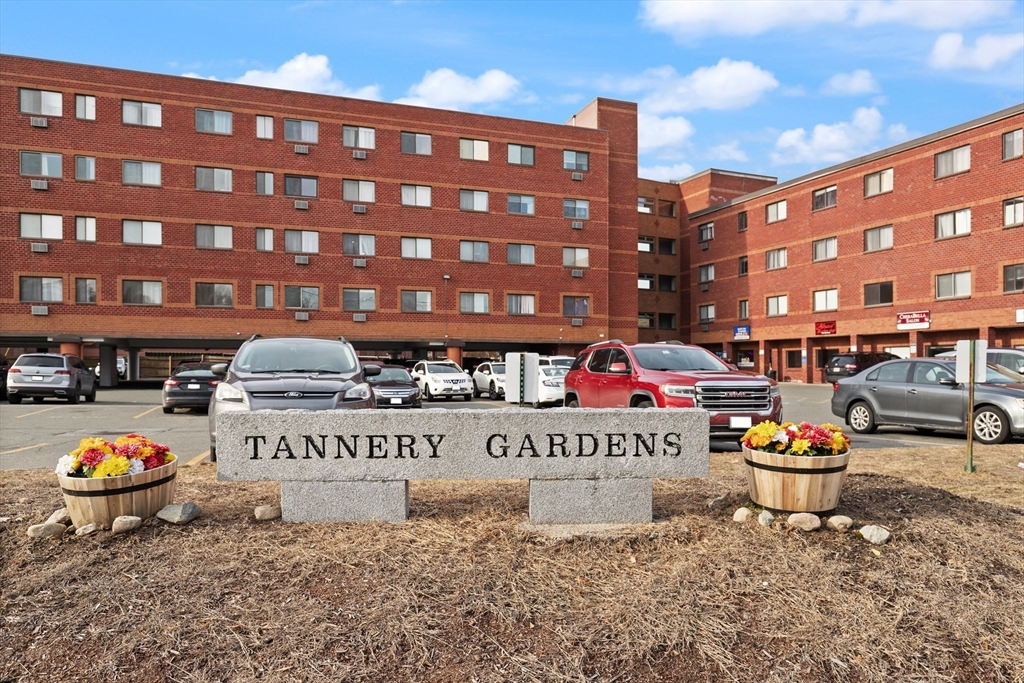 a front view of a building with table and chairs