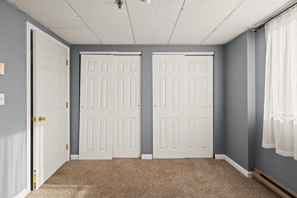 111 Foster Street, Unit 305 Peabody, MA 01960 - Photo 17 of 24 an empty room with windows