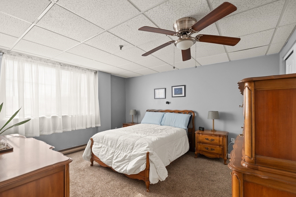 111 Foster Street, Unit 305 Peabody, MA 01960 - Photo 18 of 24 a bedroom with a bed and window