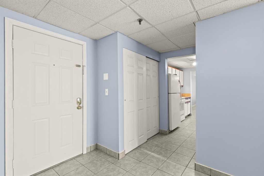 111 Foster Street, Unit 305 Peabody, MA 01960 - Photo 3 of 24 a view of a hallway with closet area