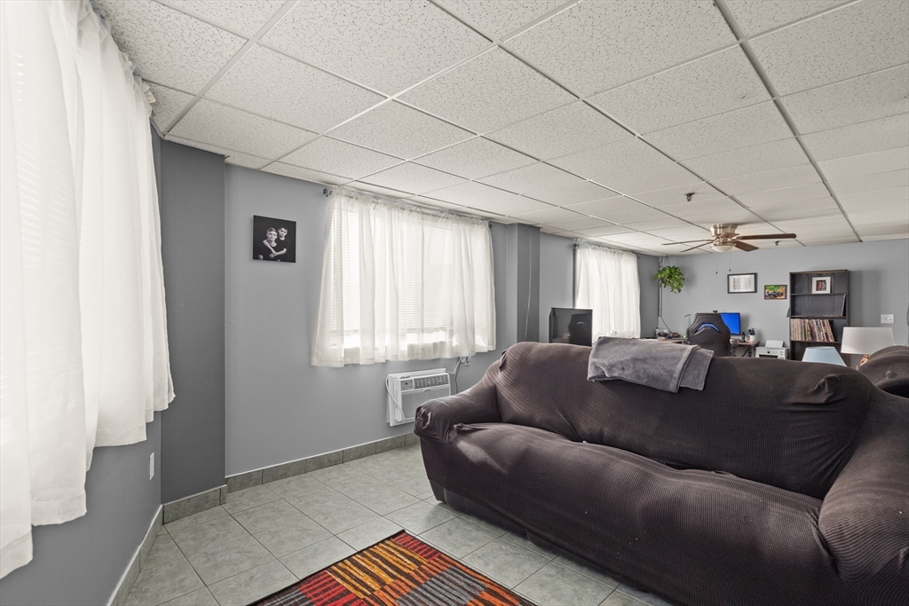 111 Foster Street, Unit 305 Peabody, MA 01960 - Photo 8 of 24 a living room with furniture and a window