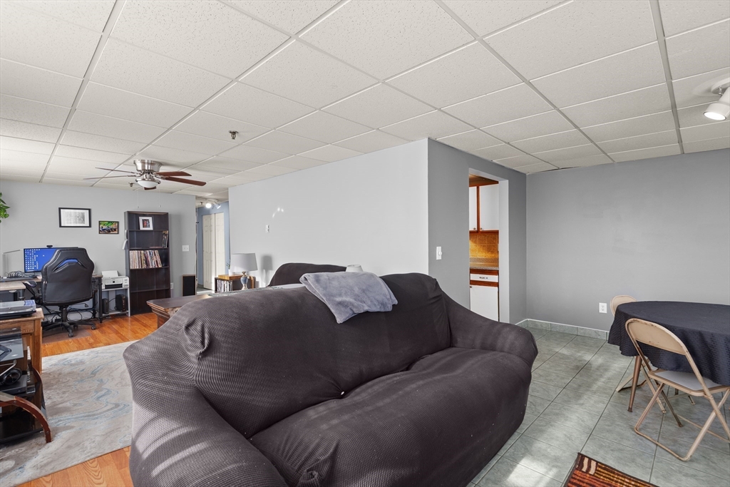 111 Foster Street, Unit 305 Peabody, MA 01960 - Photo 9 of 24 a living room with furniture a couch and dresser
