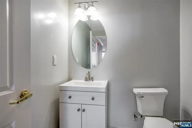 a bathroom with a toilet sink and mirror