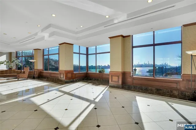 a living room with furniture and large windows