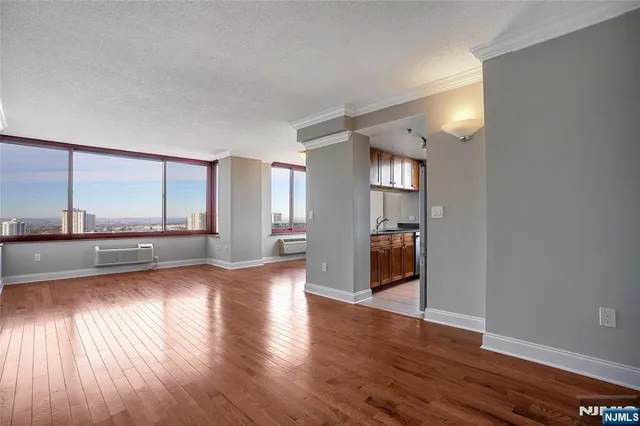 a view of a living room a window and wooden floor