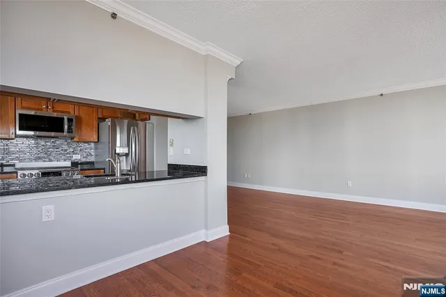 a view of a kitchen with wooden floor and a sink