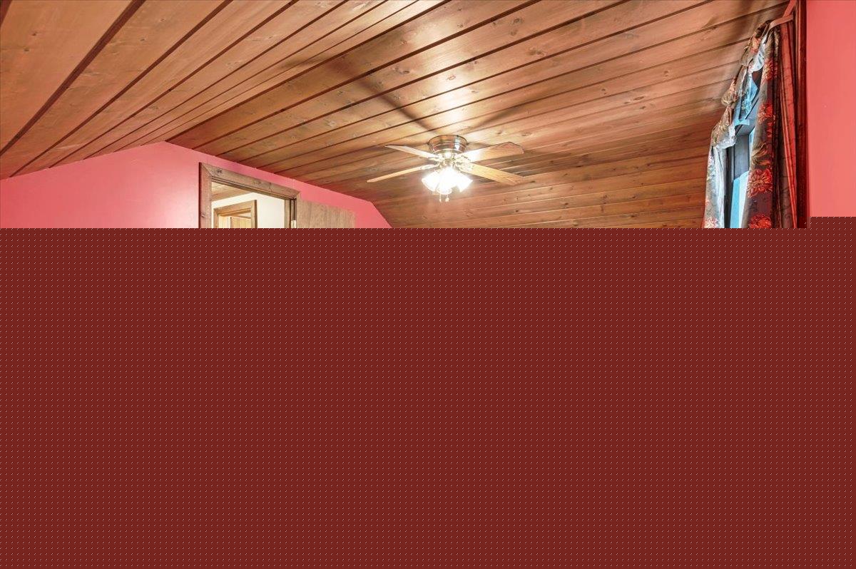 980 West Predmore Road Oakland, MI 48363 - Photo 9 of 11 Room featuring sloped wood-paneled ceilings, textured carpeting, and a ceiling fan with integrated lighting