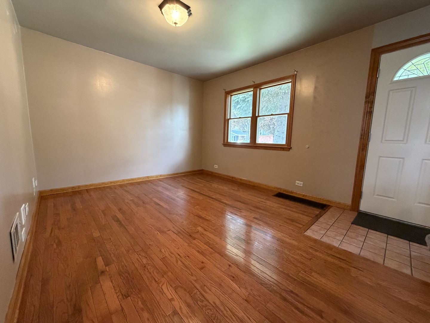 7841 45th Place Lyons, IL 60534 - Photo 12 of 23 an empty room with wooden floor and windows