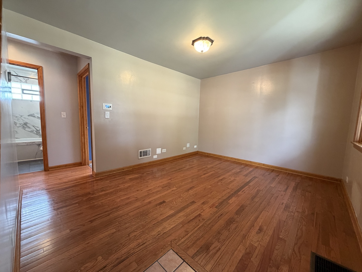 7841 45th Place Lyons, IL 60534 - Photo 10 of 23 wooden floor in an empty room with a window