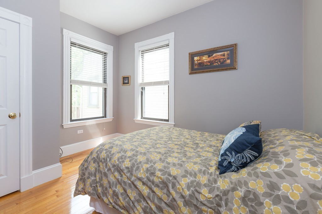 40 Rockview Street, Unit 4 Boston, MA 02130 - Photo 5 of 8 a bed sitting in a bedroom next to a window