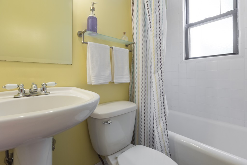 40 Rockview Street, Unit 4 Boston, MA 02130 - Photo 6 of 8 a white toilet sitting next to a bathroom sink