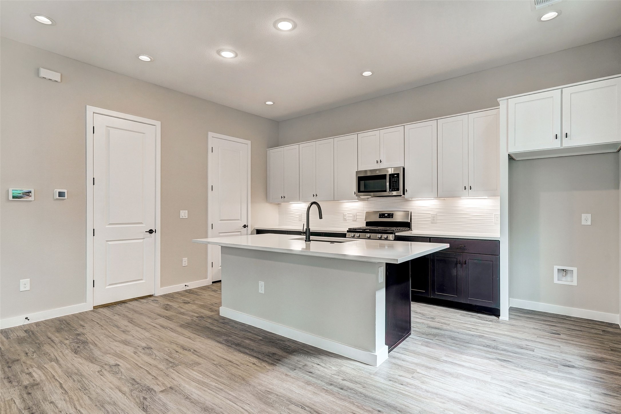 3809 Valley View Road, Unit 13 Austin, TX 78704 - Photo 12 of 30 Kitchen with quartz counter tops & white cabinets