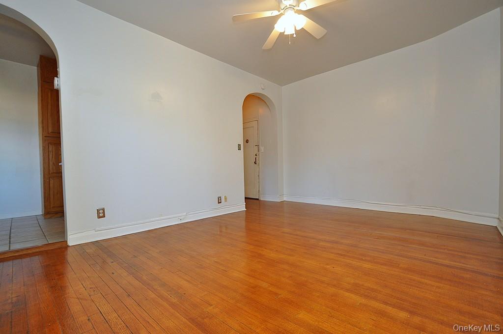 120 Stonelea Place, Unit 3M New Rochelle, NY 10801 - Photo 11 of 39 an empty room with wooden floor closet and chandelier
