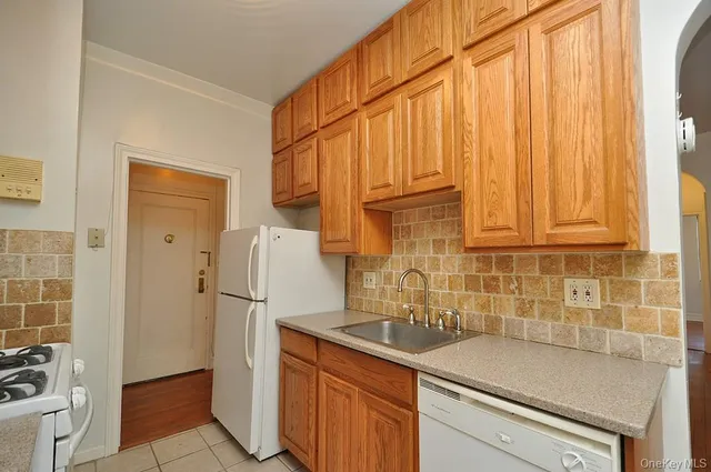 a kitchen with stainless steel appliances a refrigerator and a sink