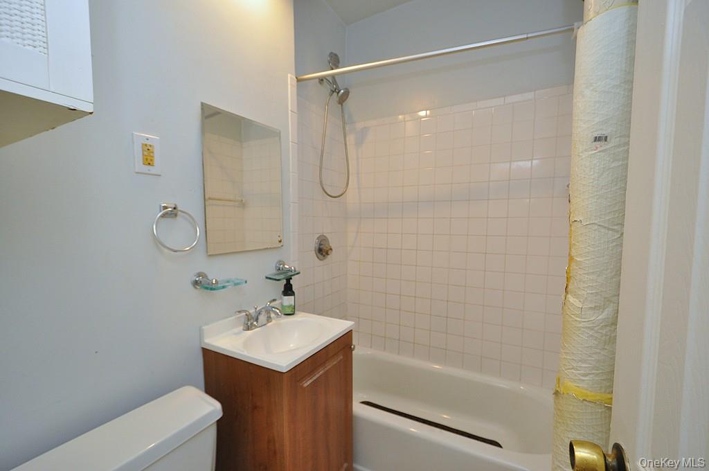 120 Stonelea Place, Unit 3M New Rochelle, NY 10801 - Photo 21 of 39 a bathroom with a bathtub shower sink vanity and a toilet