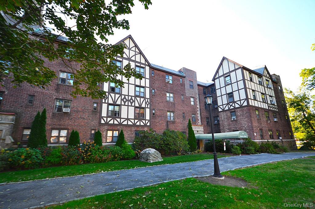 120 Stonelea Place, Unit 3M New Rochelle, NY 10801 - Photo 25 of 39 a view of a building next to a yard