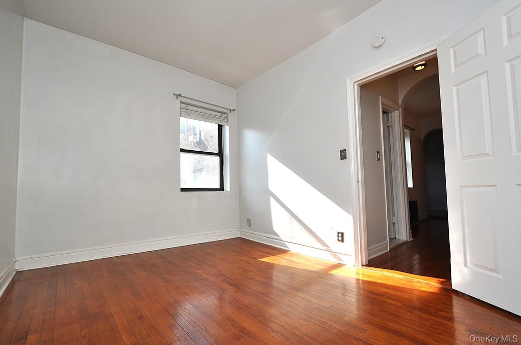 120 Stonelea Place, Unit 3M New Rochelle, NY 10801 - Photo 32 of 39 an empty room with wooden floor and windows