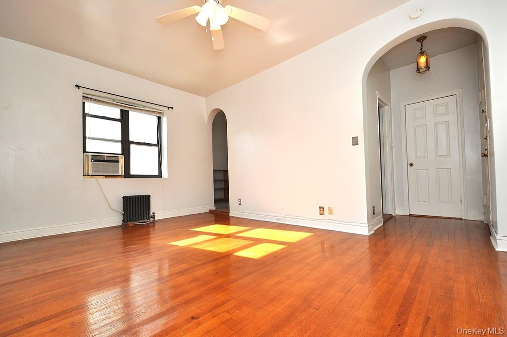 120 Stonelea Place, Unit 3M New Rochelle, NY 10801 - Photo 38 of 39 a view of an empty room with window and wooden floor