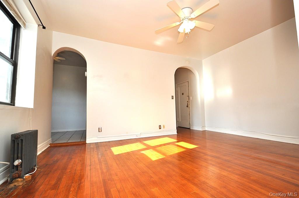 120 Stonelea Place, Unit 3M New Rochelle, NY 10801 - Photo 39 of 39 a view of a room with wooden floor and a ceiling fan
