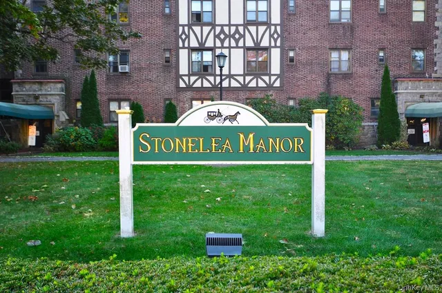 a view of a brick house with a yard