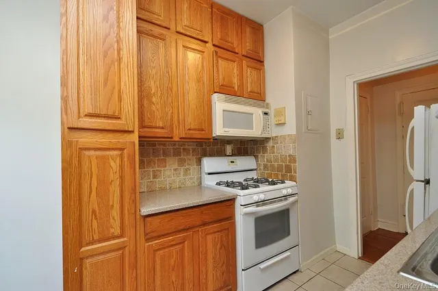 a kitchen with stainless steel appliances a refrigerator stove and cabinets