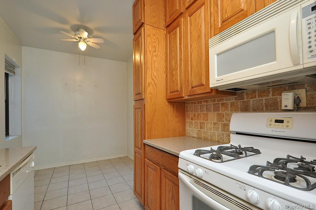 120 Stonelea Place, Unit 3M New Rochelle, NY 10801 - Photo 7 of 39 a kitchen with a stove and cabinets