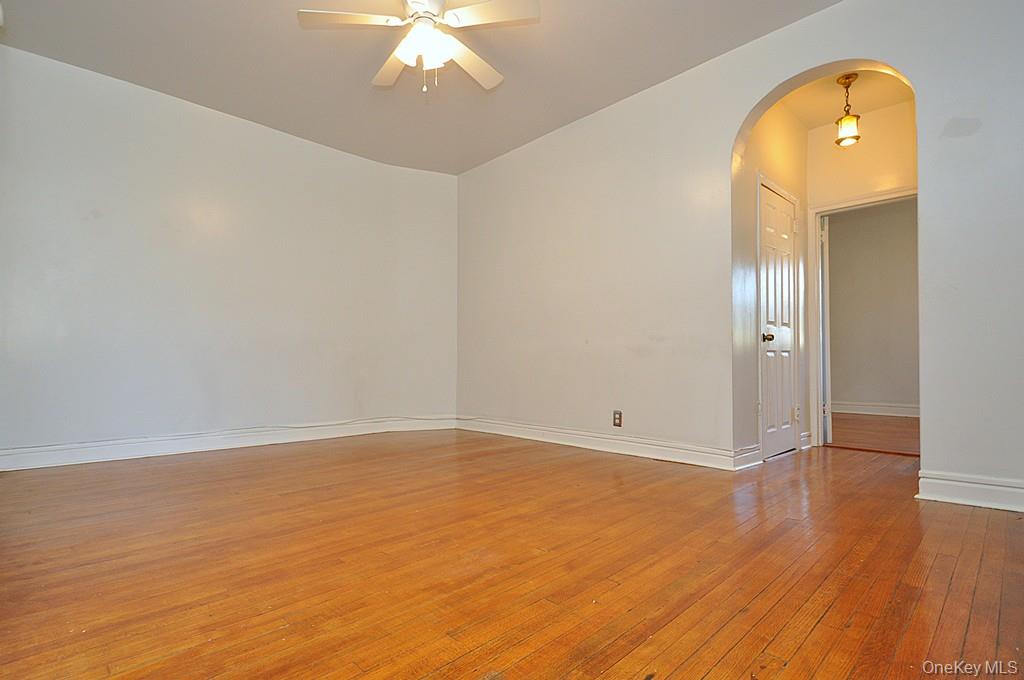 120 Stonelea Place, Unit 3M New Rochelle, NY 10801 - Photo 10 of 39 an empty room with wooden floor and mirror