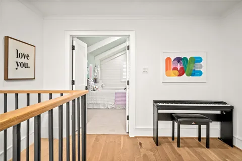 a bedroom with furniture and a large window