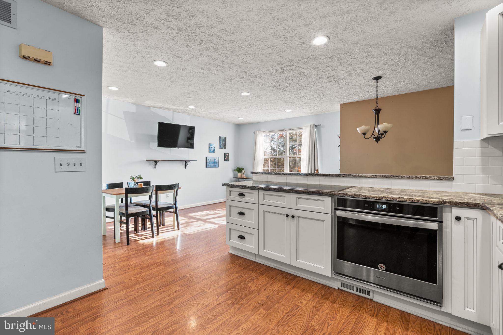 802 203rd Street Pasadena, MD 21122 - Photo 12 of 37 a kitchen with stainless steel appliances granite countertop a stove a sink and a refrigerator