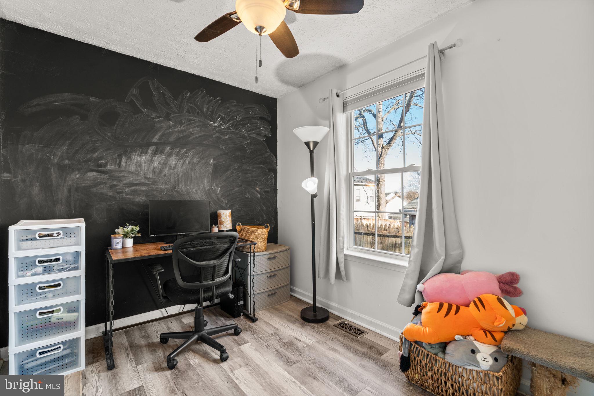 802 203rd Street Pasadena, MD 21122 - Photo 15 of 37 a bedroom with a baby bed a chandelier and a window