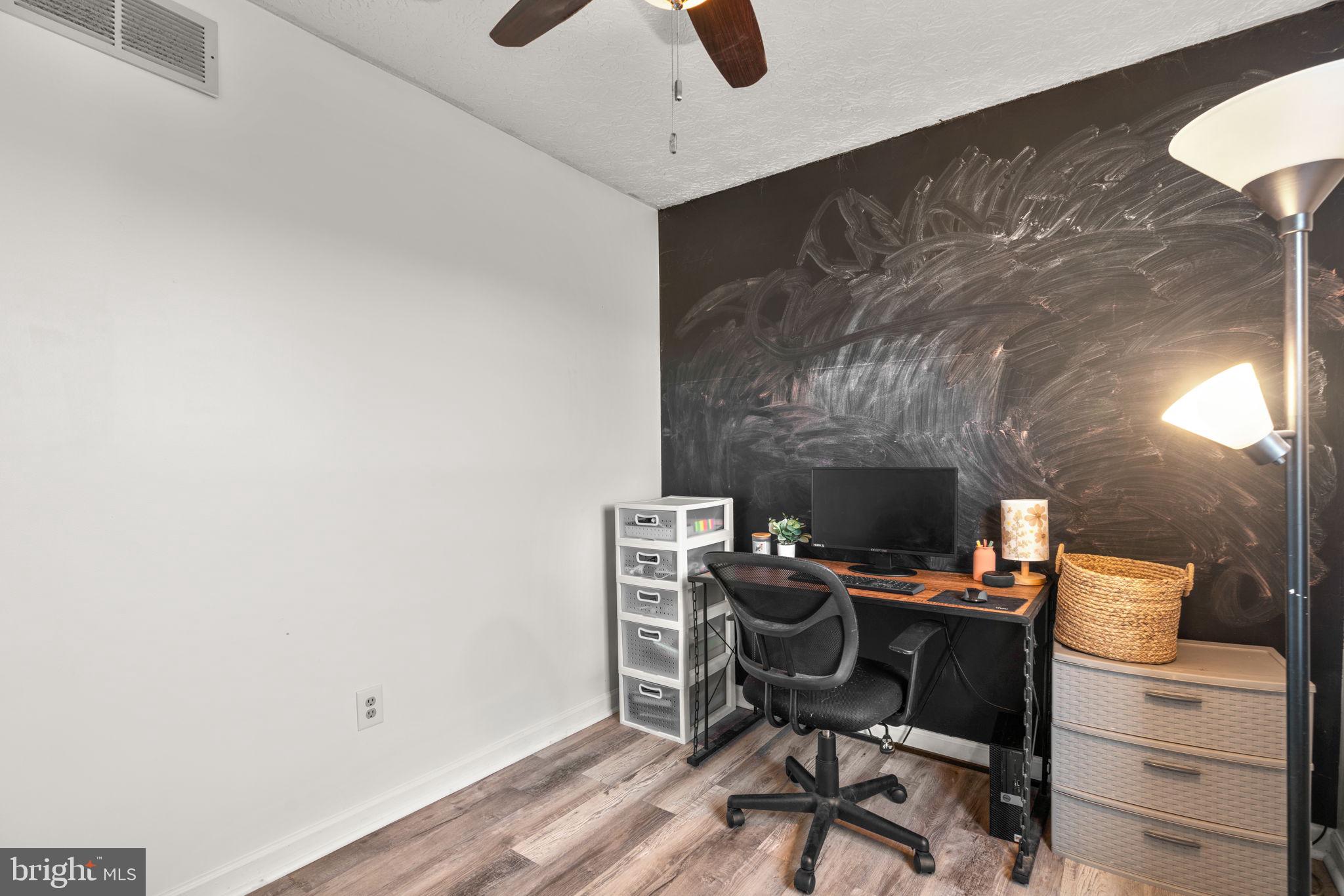 802 203rd Street Pasadena, MD 21122 - Photo 16 of 37 a workspace with furniture and a fireplace