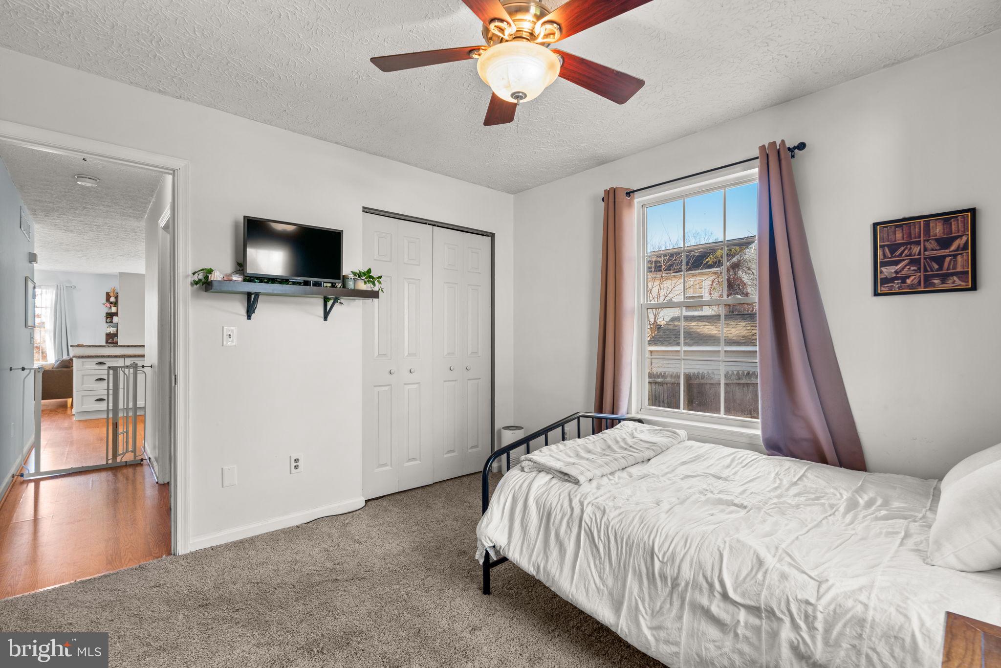 802 203rd Street Pasadena, MD 21122 - Photo 20 of 37 a bedroom with a bed and a flat screen tv