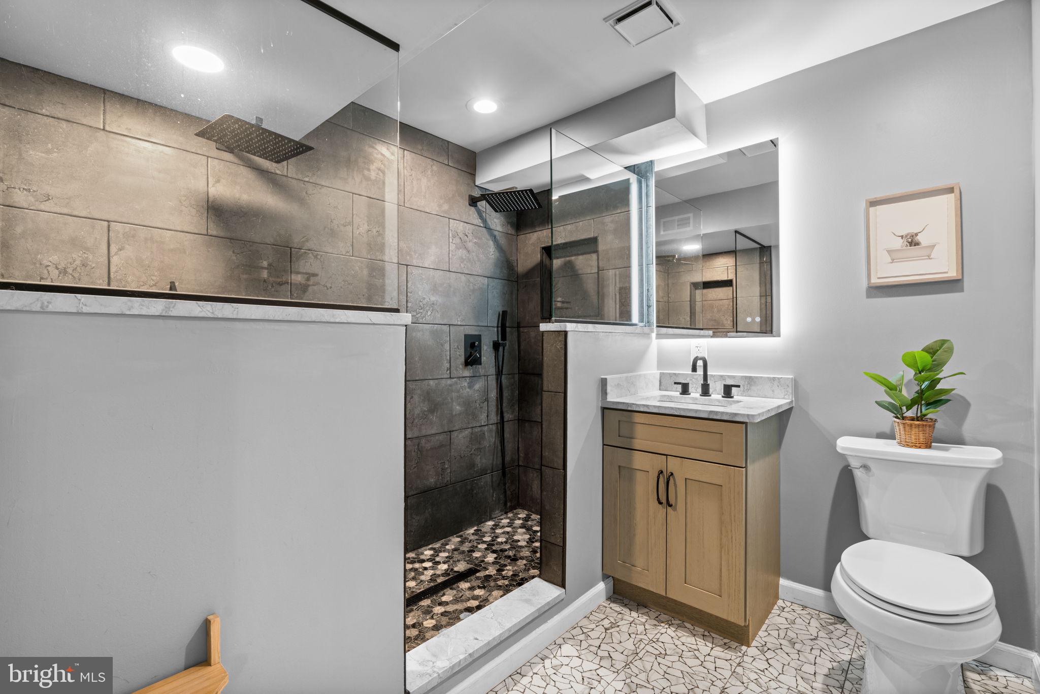 802 203rd Street Pasadena, MD 21122 - Photo 28 of 37 a bathroom with a granite countertop sink toilet and shower