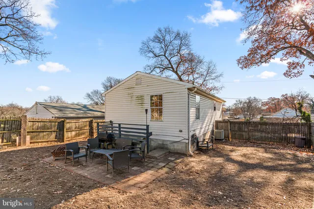 a view of backyard with outdoor seating and trees