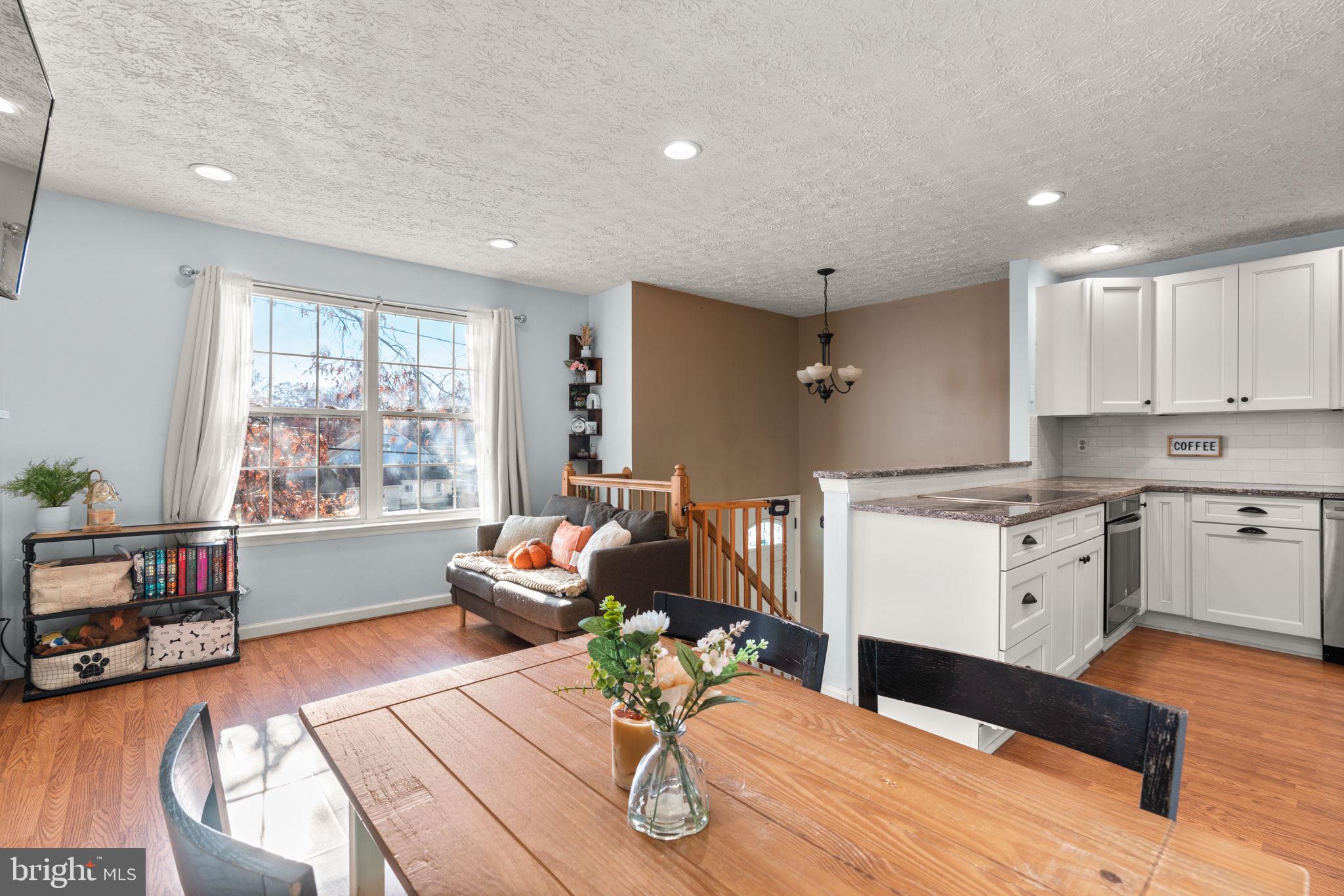 802 203rd Street Pasadena, MD 21122 - Photo 8 of 37 a kitchen with a table chairs wooden floors and a view of living room