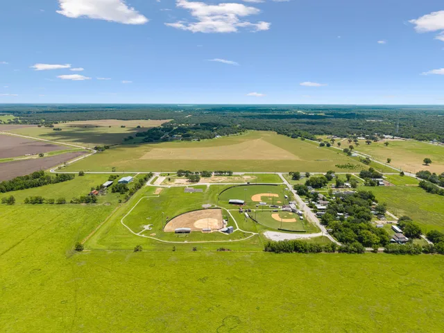 an aerial view of a houses with a ocean view