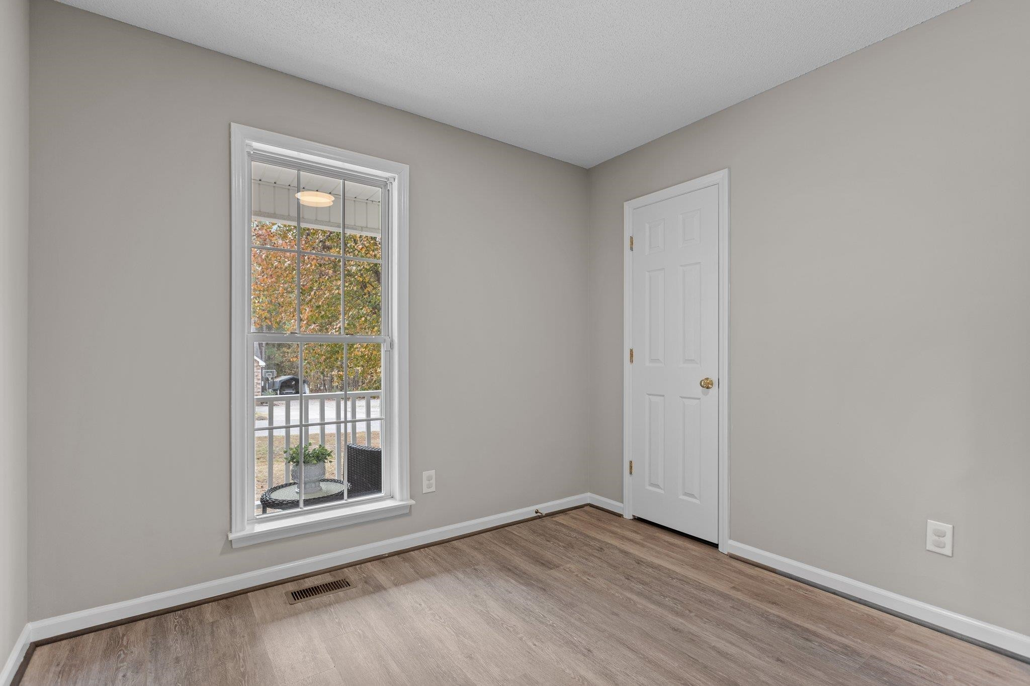 2032 Ruddy Road Raleigh, NC 27616 - Photo 17 of 27 an empty room with wooden floor and windows