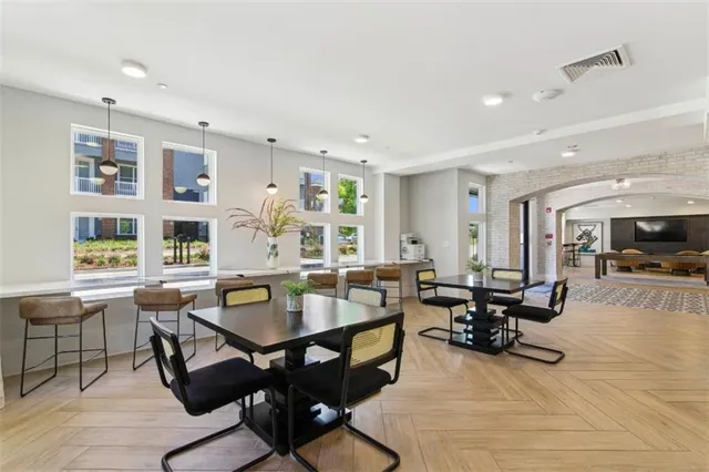 a living room with furniture a rug and a large window