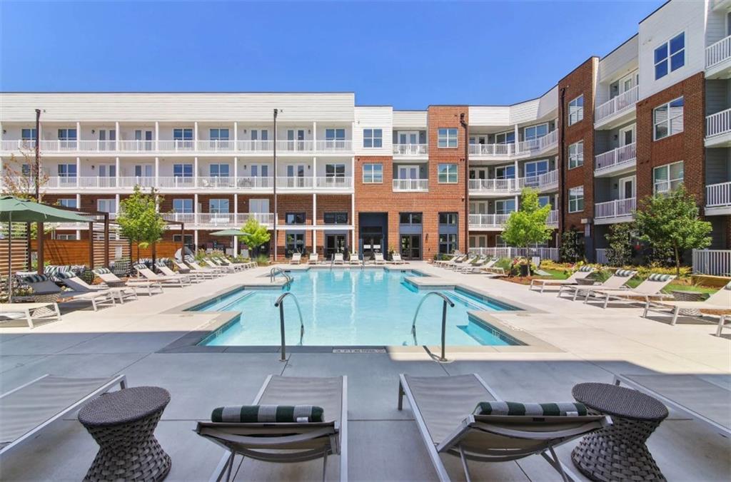 550 Webb Gin House Road, Unit 2406 Lawrenceville, GA 30045 - Photo 19 of 22 a view of a swimming pool with a lounge chair