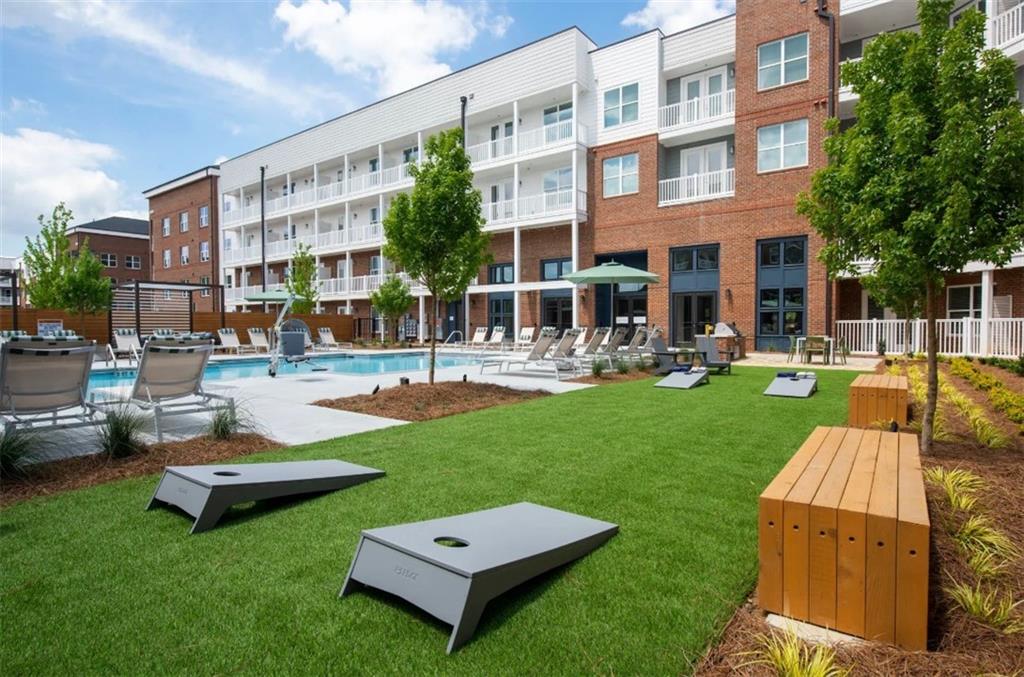 550 Webb Gin House Road, Unit 2406 Lawrenceville, GA 30045 - Photo 21 of 22 a view of a building with garden and sitting area