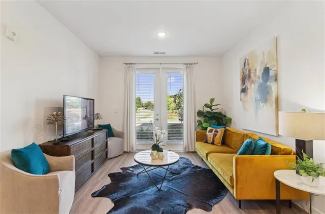 a living room with furniture and a potted plant