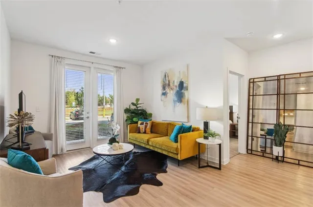 a living room with furniture and wooden floor