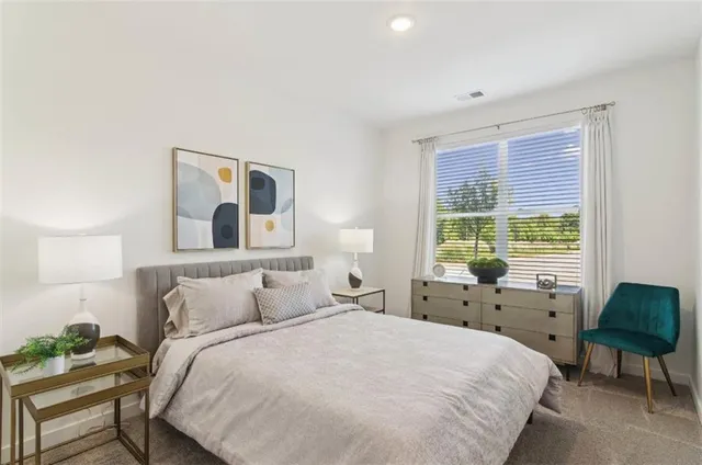 a bedroom with a bed and a large window