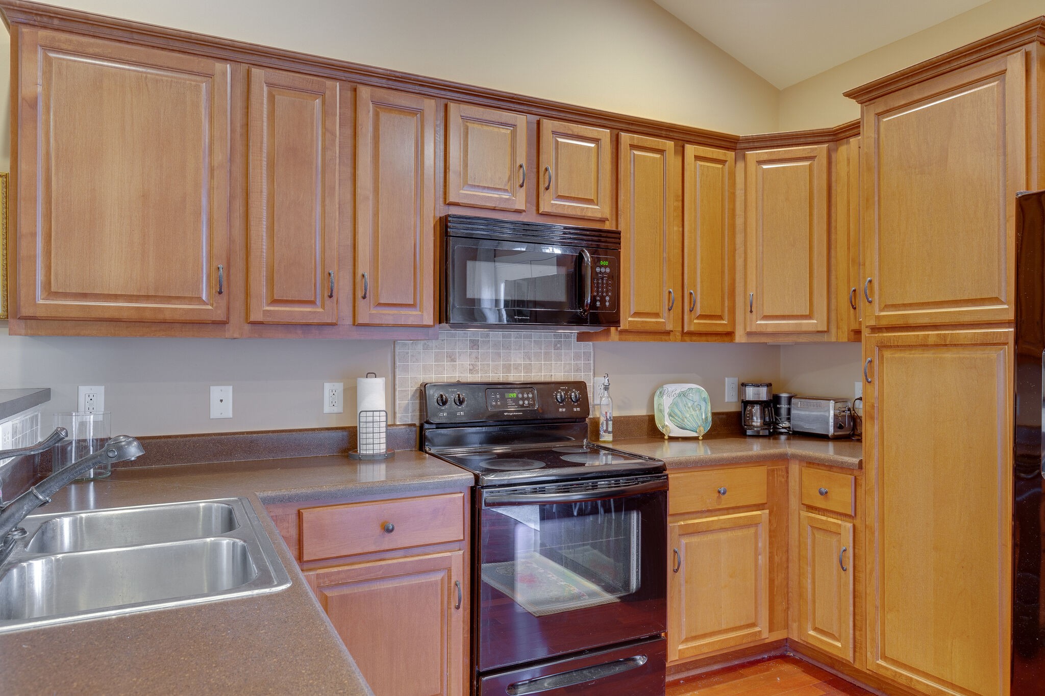 102 Westview Drive Spring Hill, TN 37174 - Photo 12 of 27 a kitchen with granite countertop wooden cabinets and a stove top oven