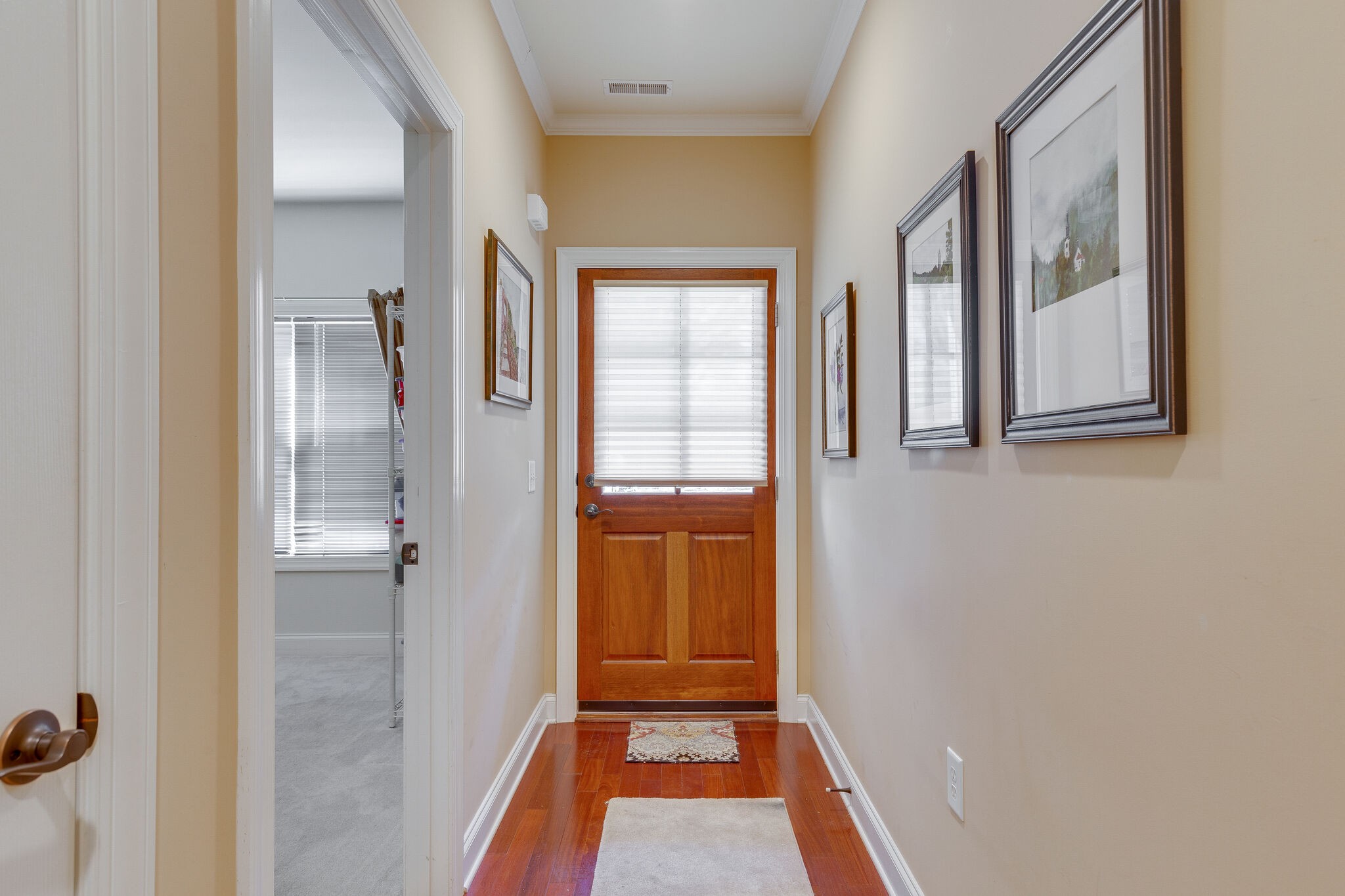 102 Westview Drive Spring Hill, TN 37174 - Photo 4 of 27 a view of a hallway with wooden floor and a bathroom
