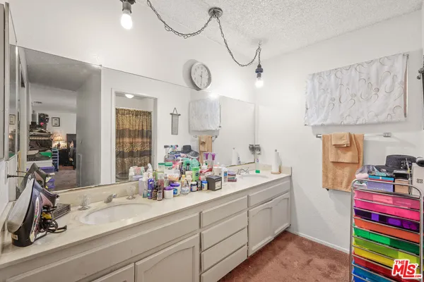 a view of storage and utility room with two washing machine