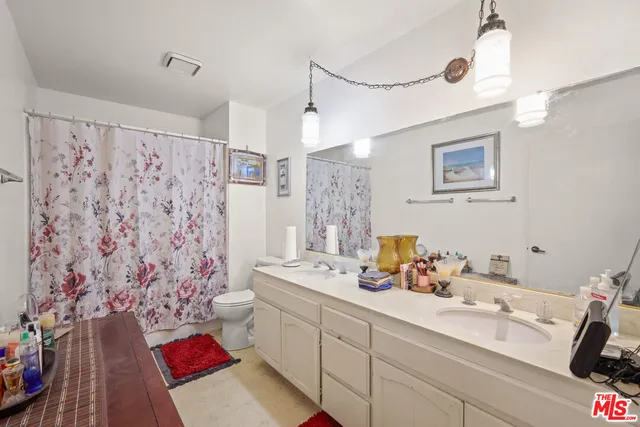 a bathroom with a sink mirror and a shower