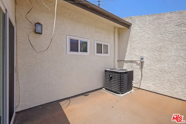 a wooden bench sitting in front of a building