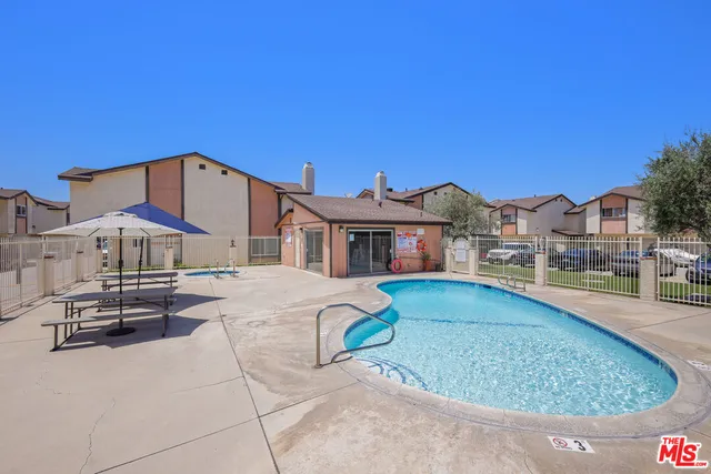 a view of a house with pool and chairs